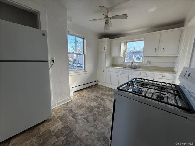 a view of empty room with a fireplace