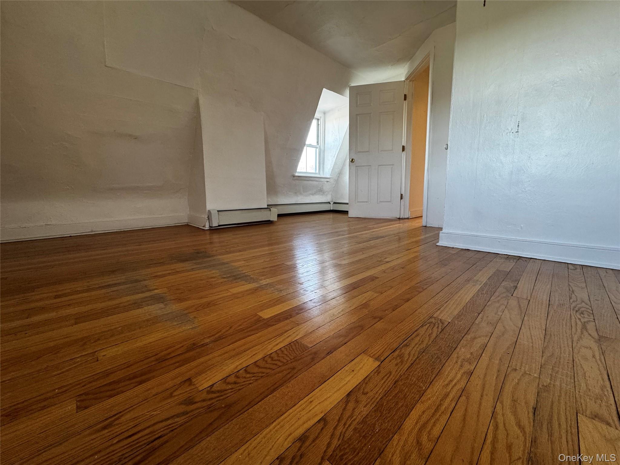 239 West Main Street, Unit 3 Goshen, NY 10924 - Photo 6 of 18 an empty room with wooden floor and windows
