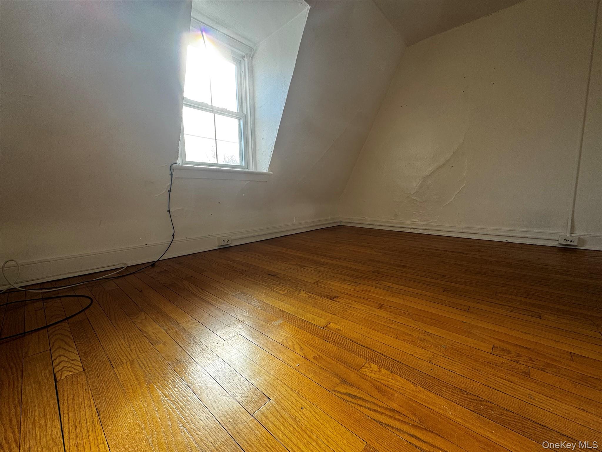 239 West Main Street, Unit 3 Goshen, NY 10924 - Photo 9 of 18 an empty room with wooden floor and windows