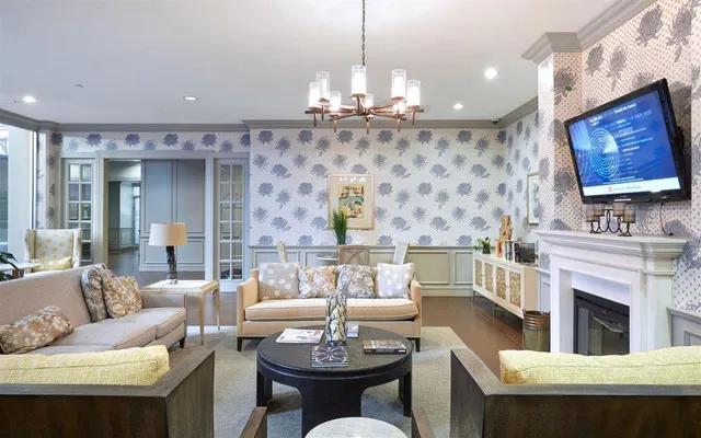 a living room with fireplace furniture and a chandelier