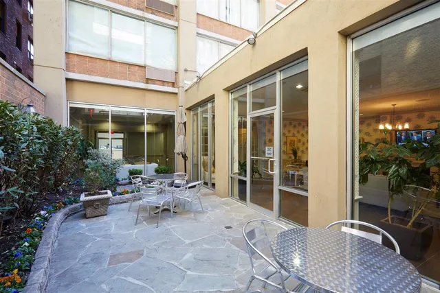 a view of a patio with table and chairs and potted plants