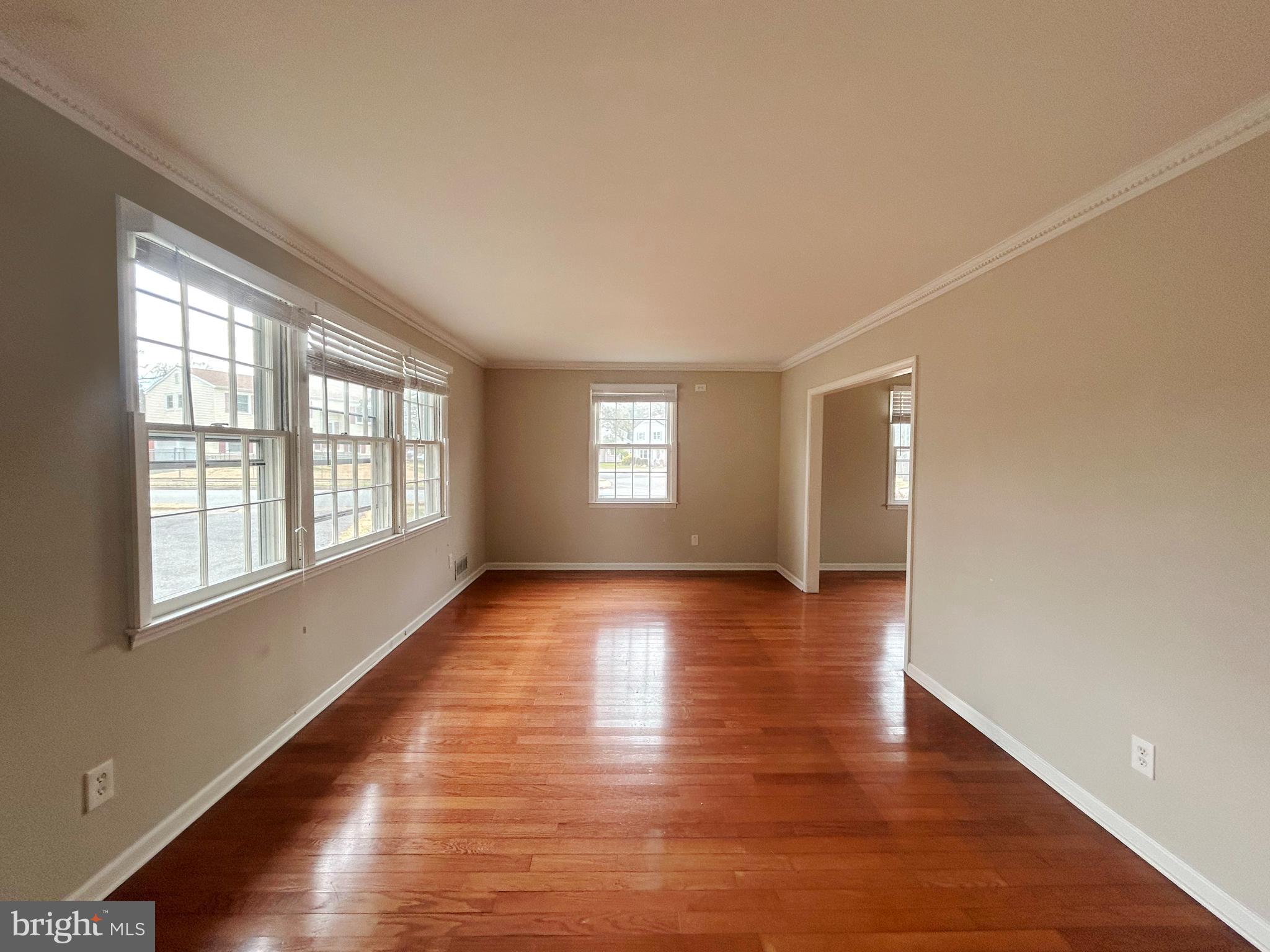 603 Hudson Avenue Pitman, NJ 08071 - Photo 3 of 17 an empty room with wooden floor and windows
