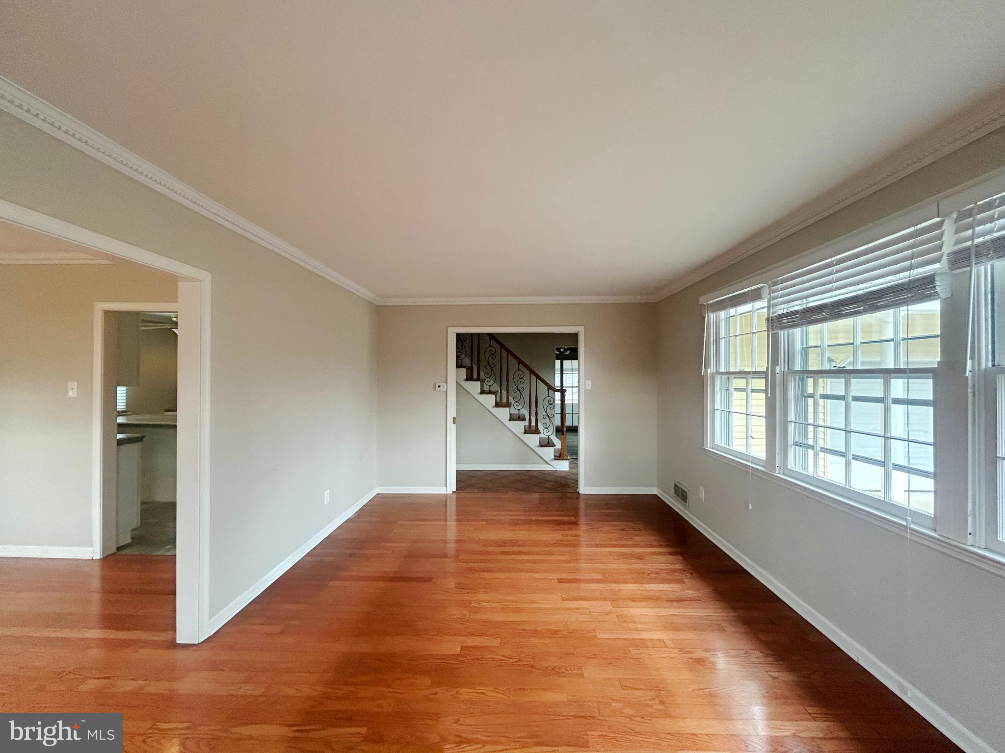 603 Hudson Avenue Pitman, NJ 08071 - Photo 4 of 17 a view of an empty room with wooden floor and a window
