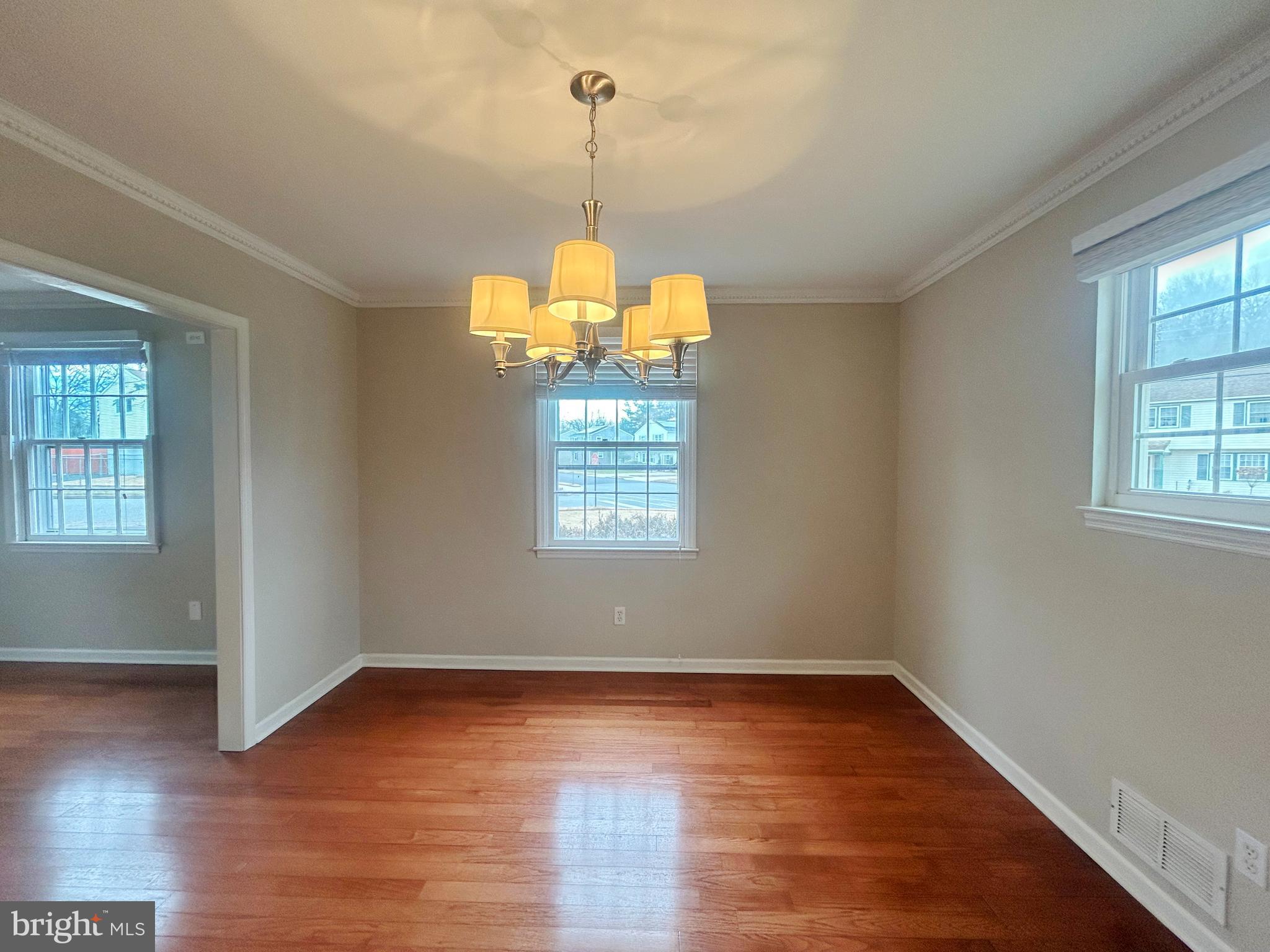 603 Hudson Avenue Pitman, NJ 08071 - Photo 6 of 17 an empty room with wooden floor and windows