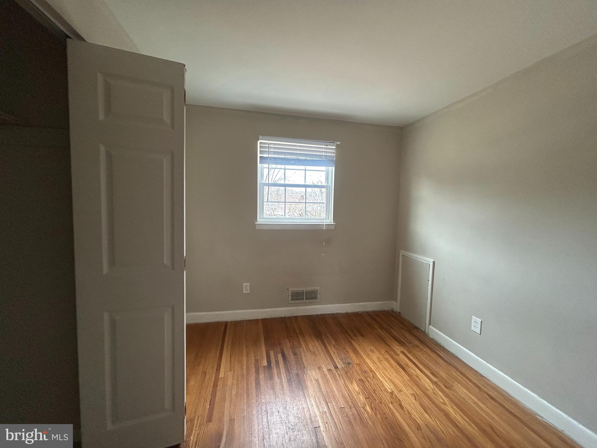 603 Hudson Avenue Pitman, NJ 08071 - Photo 10 of 17 wooden floor in an empty room with a window