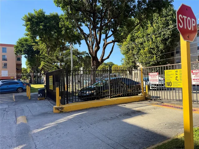 a view of a park with iron fence