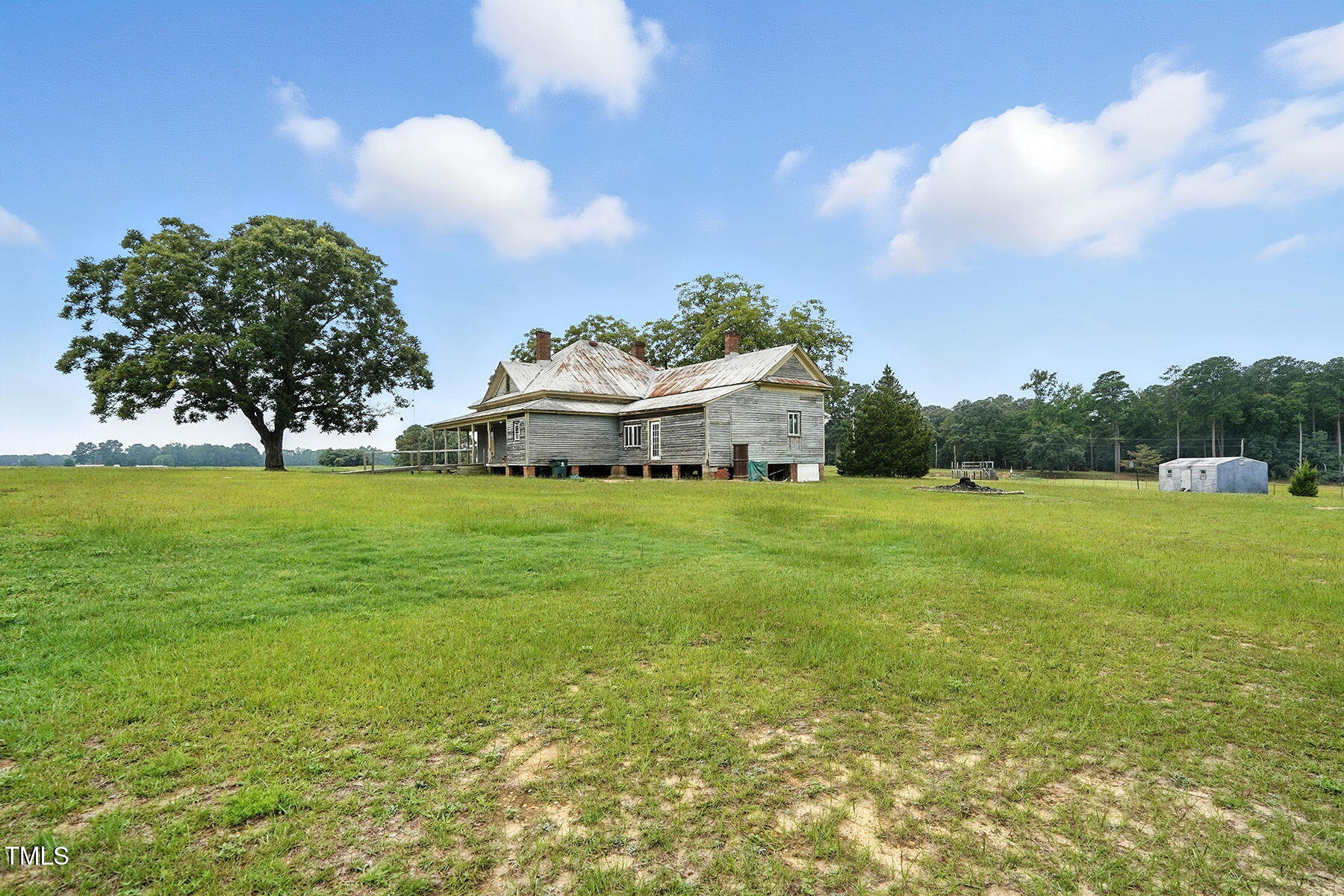 1200 D Morgan Road Benson, NC 27504 - Photo 11 of 35 a white house with a big yard and large trees