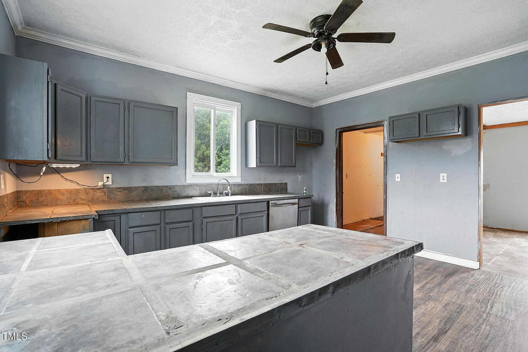 1200 D Morgan Road Benson, NC 27504 - Photo 29 of 35 a kitchen with stainless steel appliances kitchen island granite countertop a refrigerator a sink dishwasher a stove and a sink with wooden floor