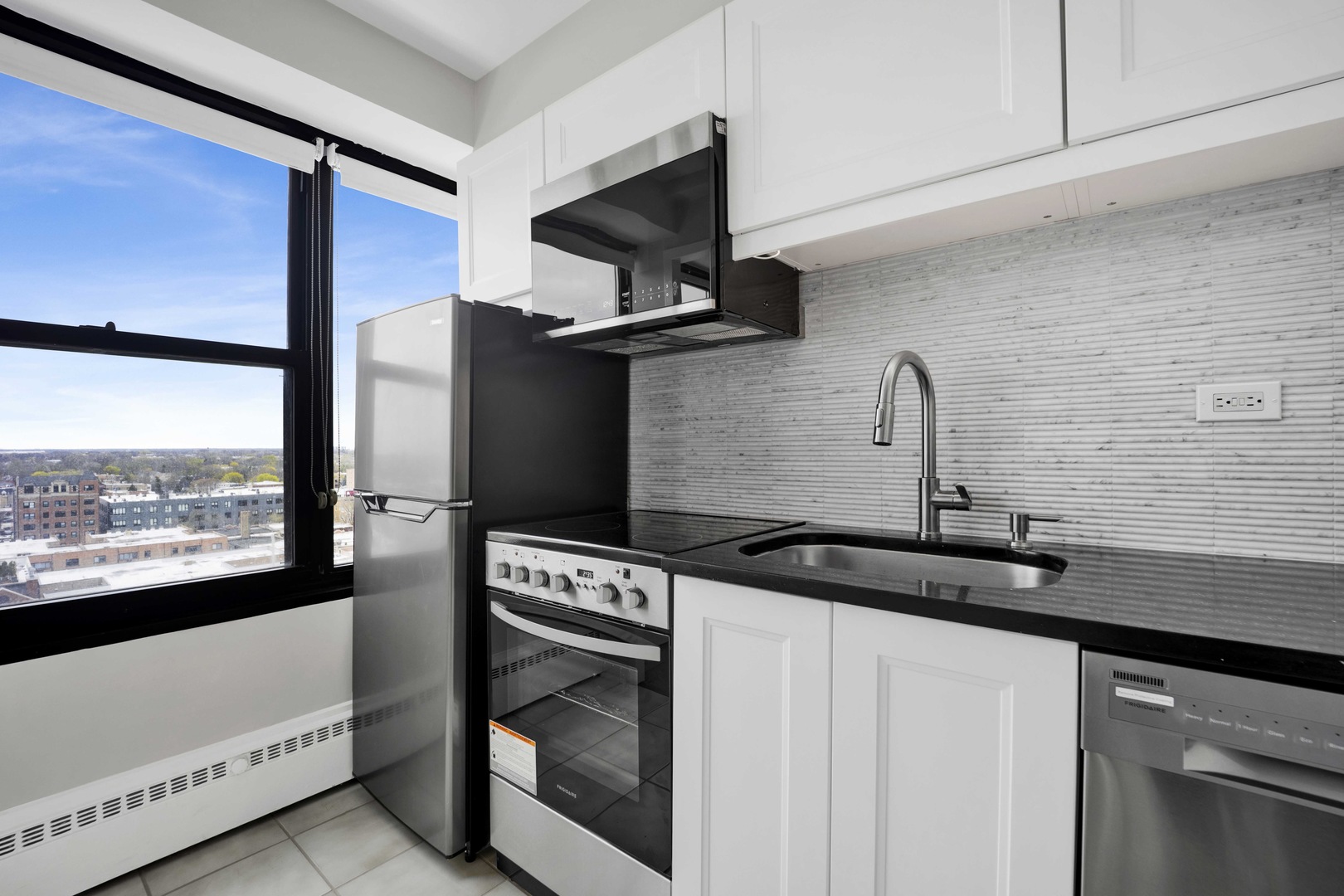 6030 North Sheridan Road, Unit 1307 Chicago, IL 60660 - Photo 5 of 18 a kitchen with a stove and a white refrigerator