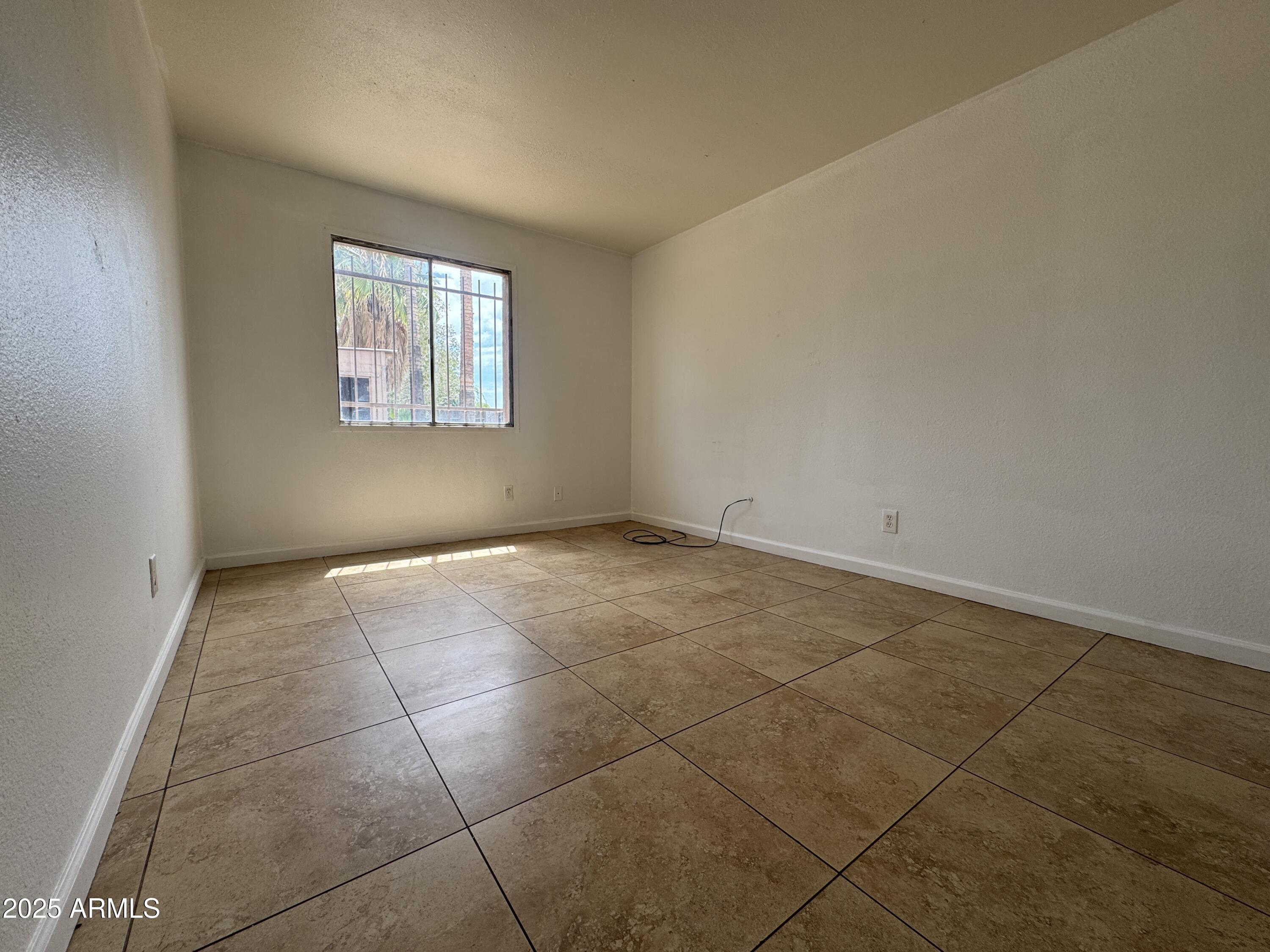 7967 West Highland Avenue Phoenix, AZ 85033 - Photo 13 of 16 a view of an empty room with a window