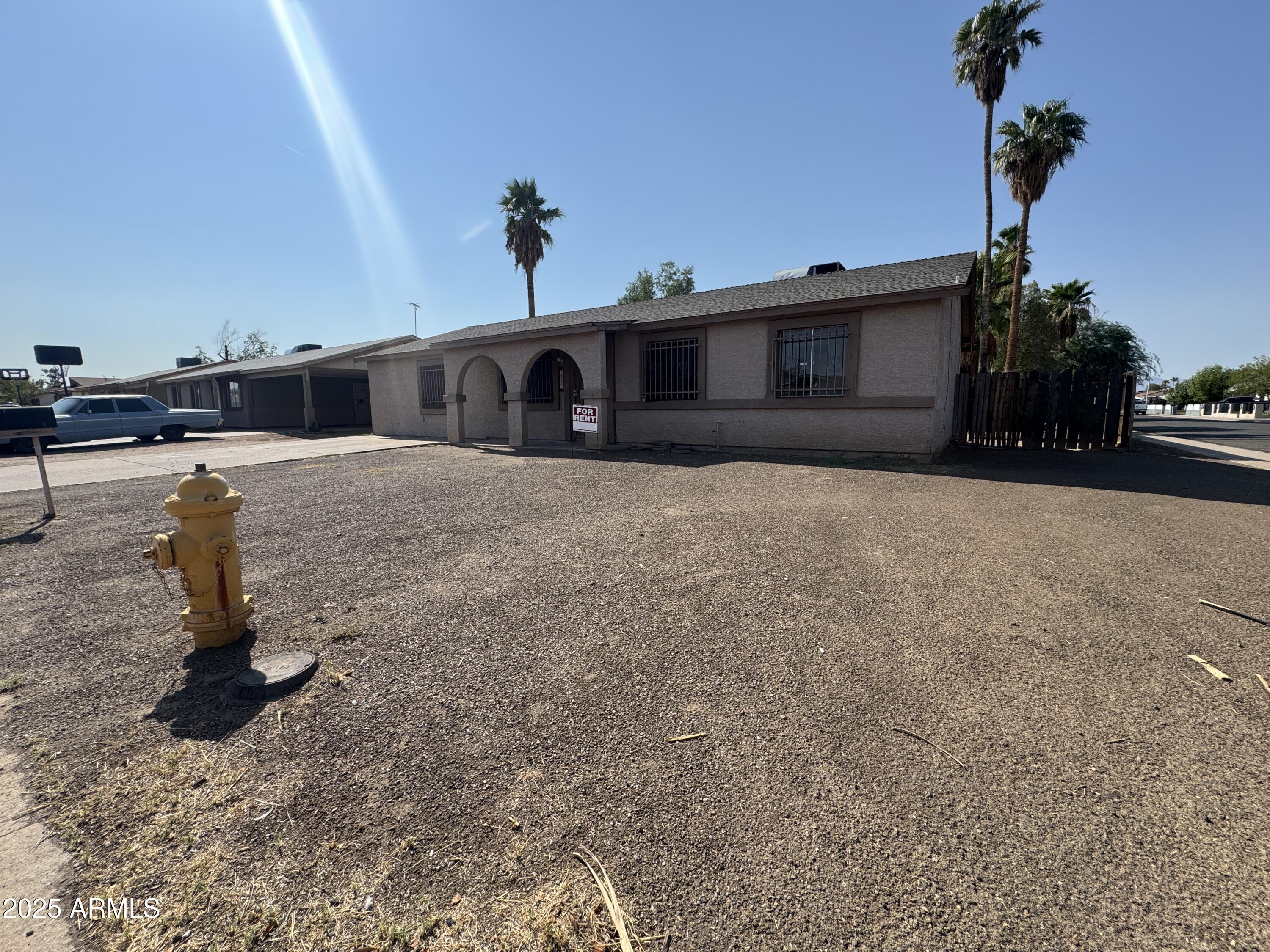 7967 West Highland Avenue Phoenix, AZ 85033 - Photo 2 of 16 a front view of a house with a yard