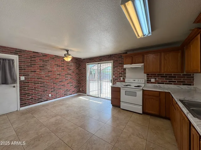a kitchen with a stove a sink and a refrigerator