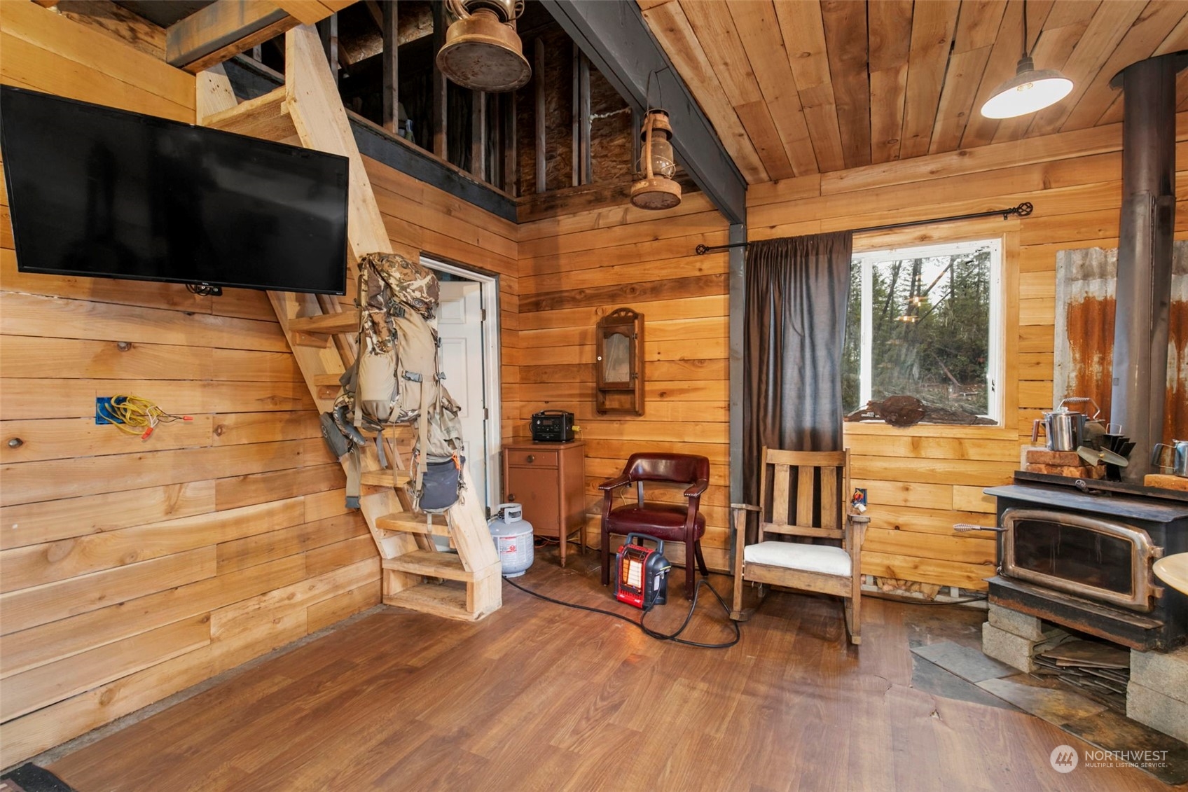 27 Northeast Dewatto Hills Road Tahuya, WA 98588 - Photo 20 of 29 a view of a balcony with furniture and a flat screen tv
