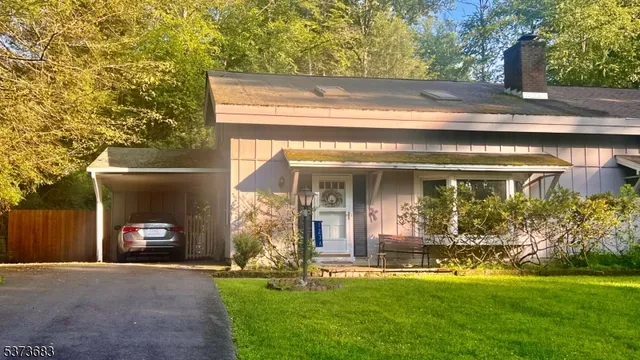 a view of a chair and table in the patio next to a yard