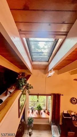 a sign board with a yard and large trees