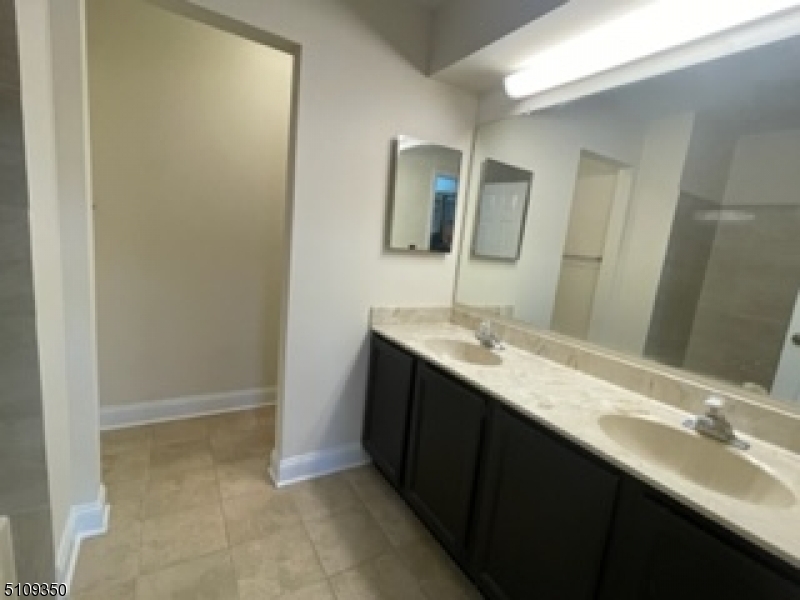 13 Andover Circle Princeton, NJ 08540 - Photo 12 of 19 a bathroom with a double vanity sink and a mirror