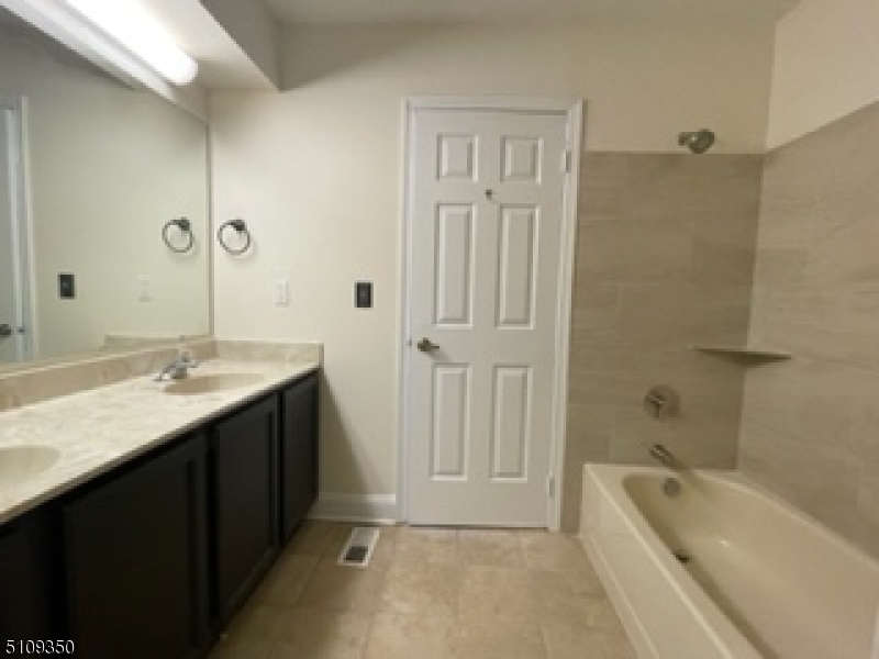 13 Andover Circle Princeton, NJ 08540 - Photo 14 of 19 a bathroom with a tub a sink and mirror