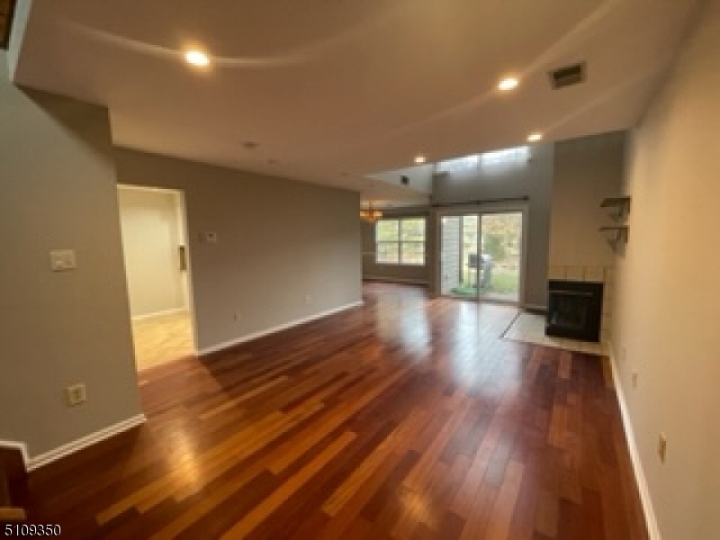 13 Andover Circle Princeton, NJ 08540 - Photo 3 of 19 an empty room with wooden floor and windows
