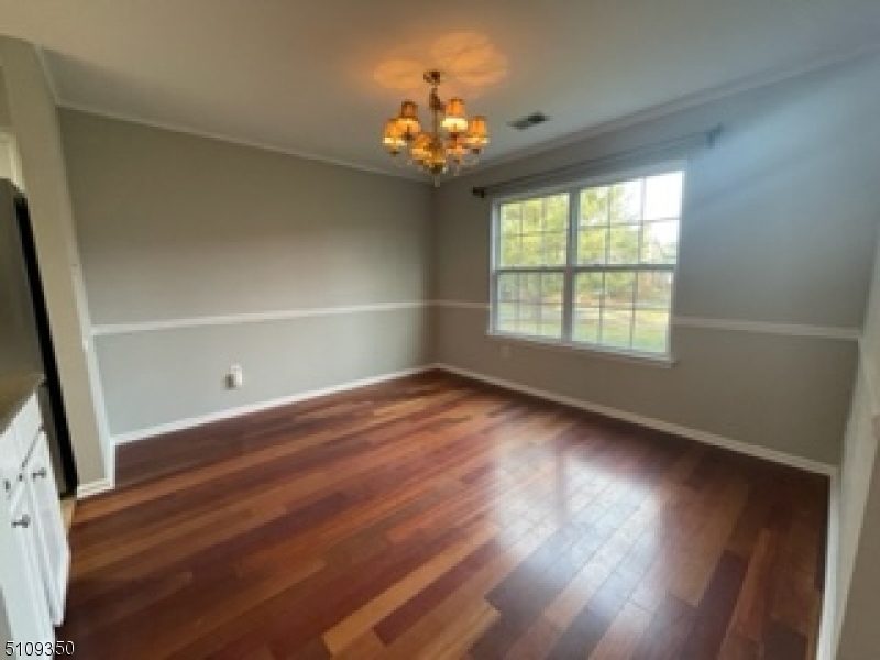 13 Andover Circle Princeton, NJ 08540 - Photo 5 of 19 a view of an empty room with wooden floor and a window