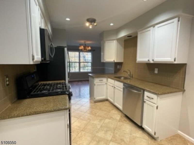13 Andover Circle Princeton, NJ 08540 - Photo 6 of 19 a kitchen with granite countertop a sink a stove and cabinets