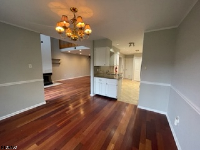 13 Andover Circle Princeton, NJ 08540 - Photo 7 of 19 a hallway with wooden floor a chandelier and entryway
