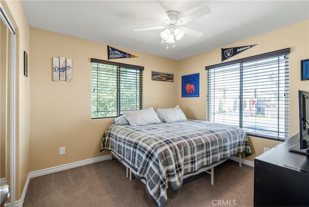 6800 Arlington Avenue Riverside, CA 92504 - Photo 16 of 25 a bedroom with a bed chandelier and a window