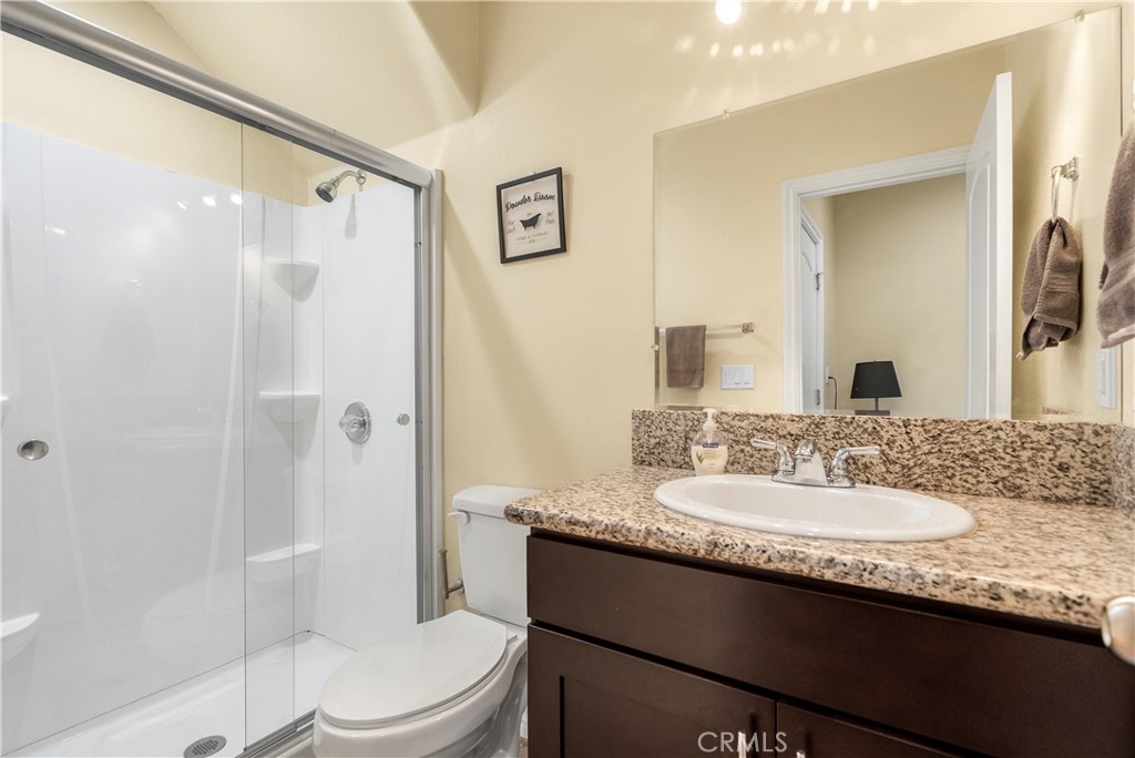 6800 Arlington Avenue Riverside, CA 92504 - Photo 20 of 25 a bathroom with a granite countertop sink mirror vanity and toilet