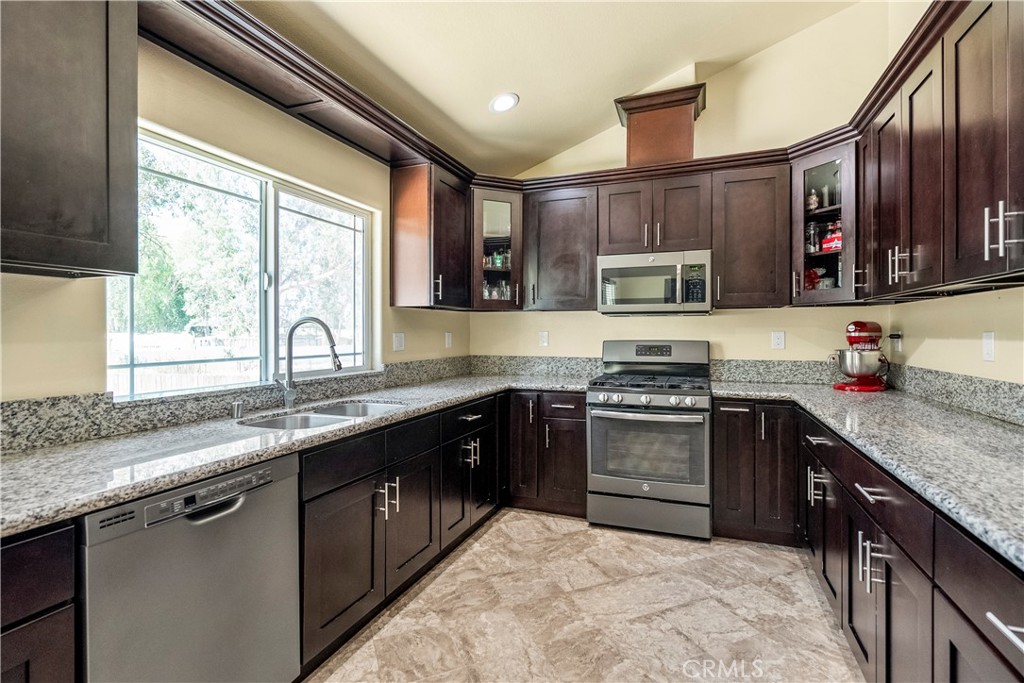 6800 Arlington Avenue Riverside, CA 92504 - Photo 6 of 25 a kitchen with stainless steel appliances granite countertop a sink stove and oven