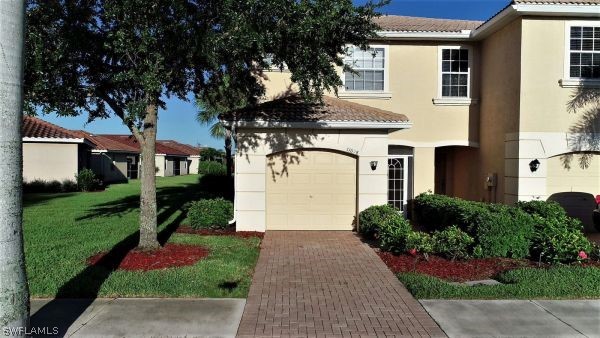 11698 Eros Road Lehigh Acres, FL 33971 - Photo 1 of 34 a front view of a house with a yard