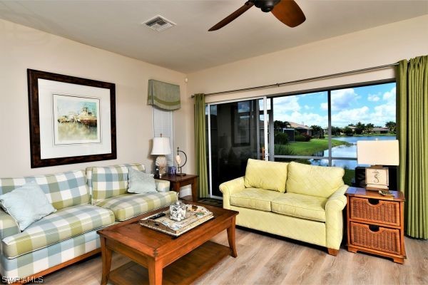 11698 Eros Road Lehigh Acres, FL 33971 - Photo 11 of 34 a living room with furniture and a large window