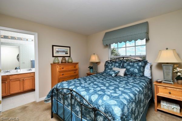 11698 Eros Road Lehigh Acres, FL 33971 - Photo 20 of 34 a bedroom with a bed and a lamp on dresser