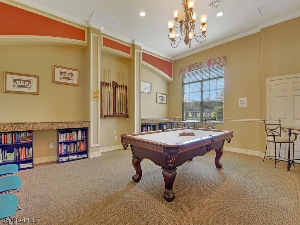 11698 Eros Road Lehigh Acres, FL 33971 - Photo 30 of 34 a room with lots of furniture and chandelier