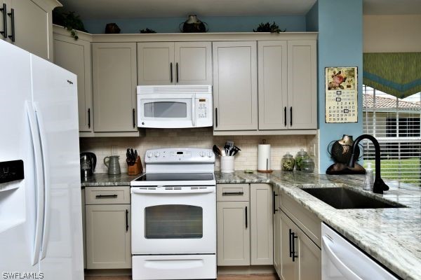 11698 Eros Road Lehigh Acres, FL 33971 - Photo 4 of 34 a kitchen with granite countertop a sink a stove and cabinets