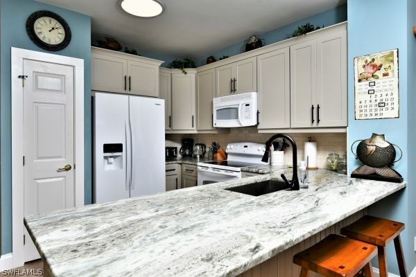 11698 Eros Road Lehigh Acres, FL 33971 - Photo 5 of 34 a kitchen with stainless steel appliances granite countertop a sink refrigerator and cabinets