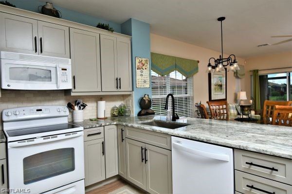 11698 Eros Road Lehigh Acres, FL 33971 - Photo 6 of 34 a kitchen with stainless steel appliances granite countertop a sink a stove and a wooden floors