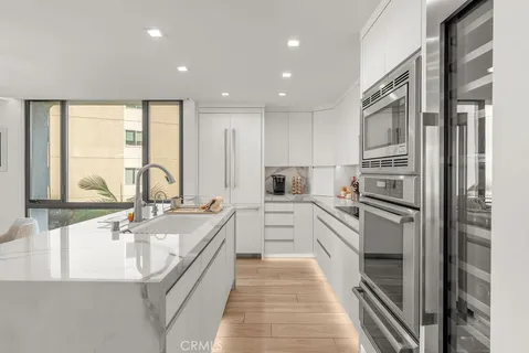 a large white kitchen with a large window