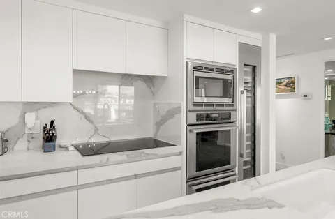 a kitchen with granite countertop a stove and cabinets