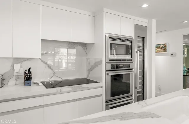 a kitchen with granite countertop a stove and cabinets