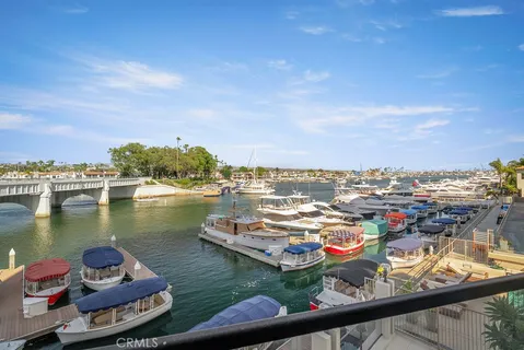 an aerial view of a residential houses with lake view and boat