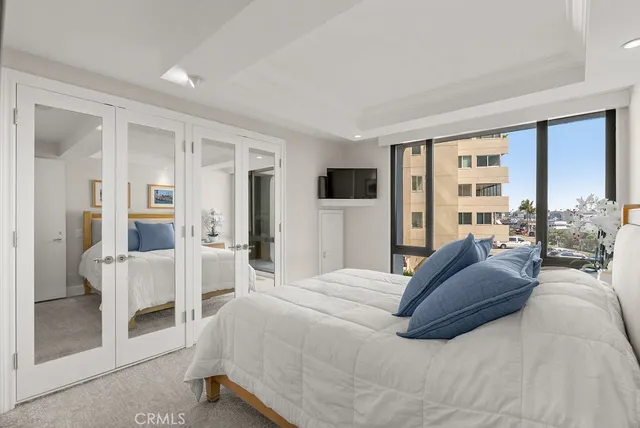 a bedroom with a large bed and a large window