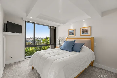 a large bed sitting in a bedroom next to a window
