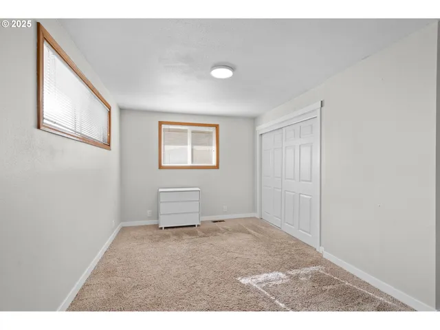 a view of a livingroom with wooden floor windows and closet