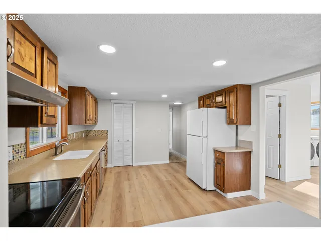 a kitchen with a sink appliances and cabinets