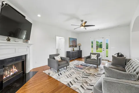 a living room with furniture a flat screen tv and a fireplace