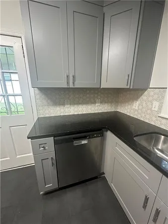 a kitchen with stainless steel appliances granite countertop a sink and a stove