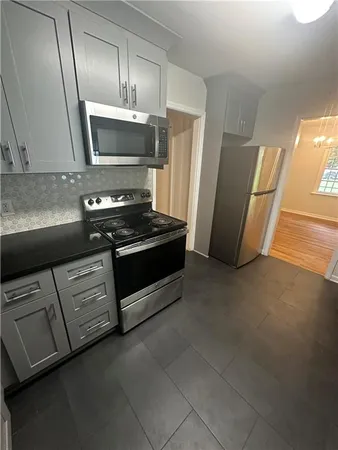 a kitchen with stainless steel appliances a refrigerator a stove a microwave and cabinets