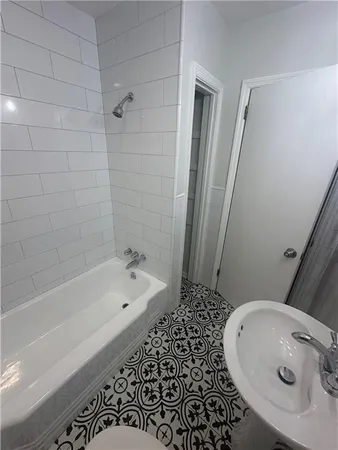 a bathroom with a bathtub and shower