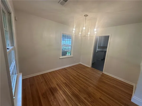 a view of a room with wooden floor and staircase