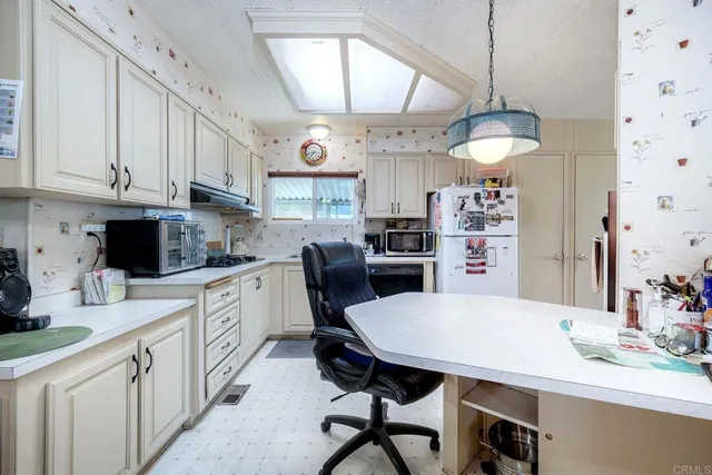a living room with furniture a chandelier and a fireplace