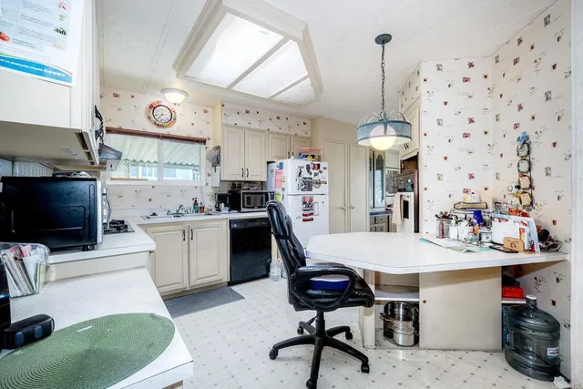 a kitchen with granite countertop cabinets stainless steel appliances and a sink
